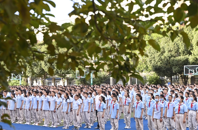 8月28日，在乌鲁木齐市第41中学，学生们参加升旗仪式。新华社